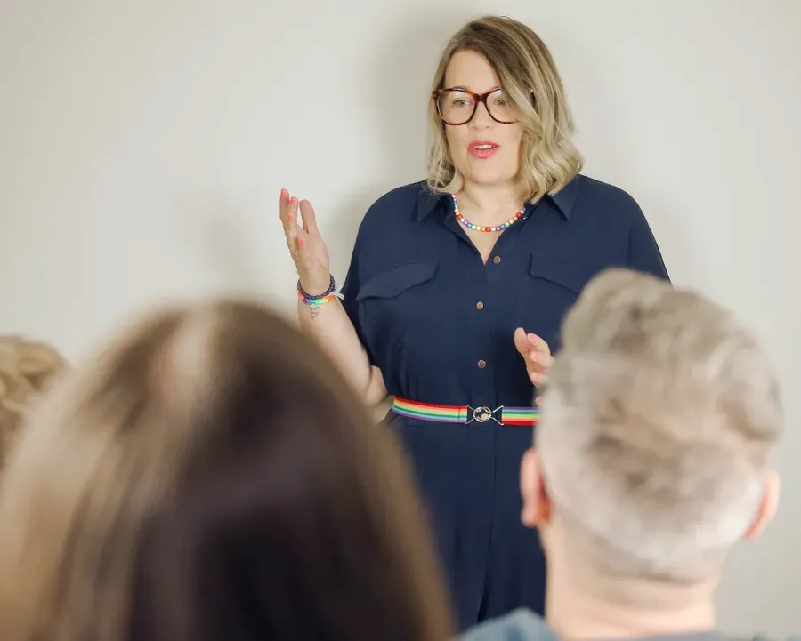 Rainbow leading a training session, speaking to a group.